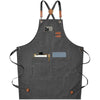 A dark gray cotton canvas apron with cross-back straps and multiple pockets.