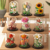A set of glass vials containing miniature floral arrangements built from building blocks.