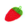 A bright red strawberry scrubber sponge with green accents.