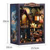 A wooden dollhouse miniature assembly kit featuring a witch's house facade with LED lighting and decorative elements.