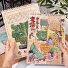 A pair of handmade paper notebooks featuring detailed 3D sticker scenes depicting pocket cabins and landscape crafts.