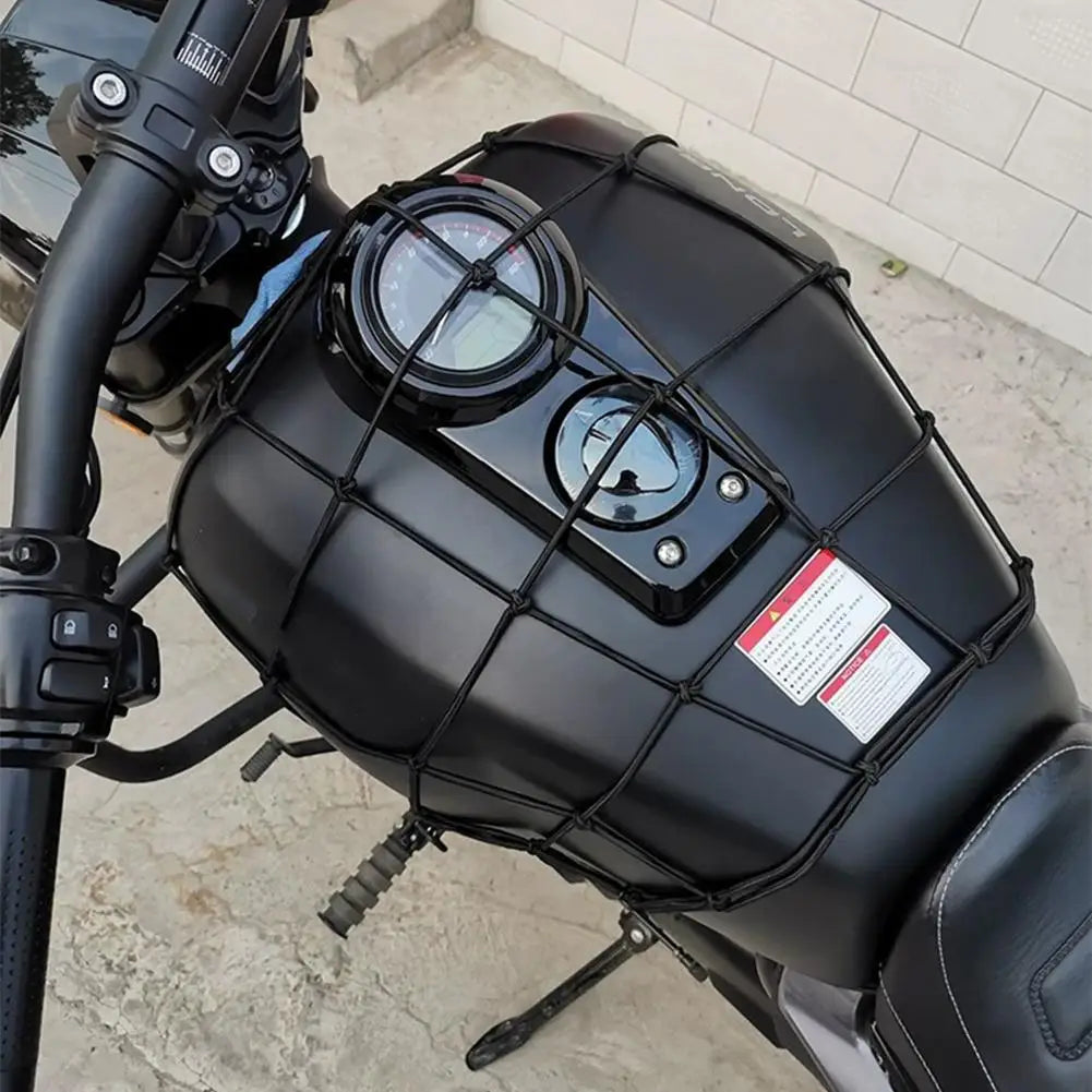A black motorcycle cargo net with scratch-free hooks is mounted on a bike frame.