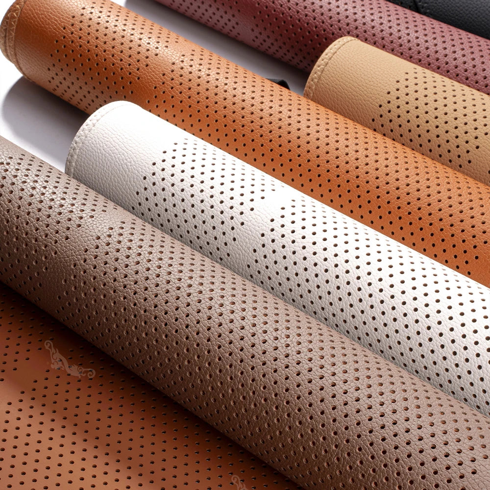 A close-up view of several breathable leather car seat cushions in various shades including brown, beige, and pink.