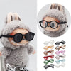A plush rabbit doll wearing black sunglasses and a fluffy gray hood.