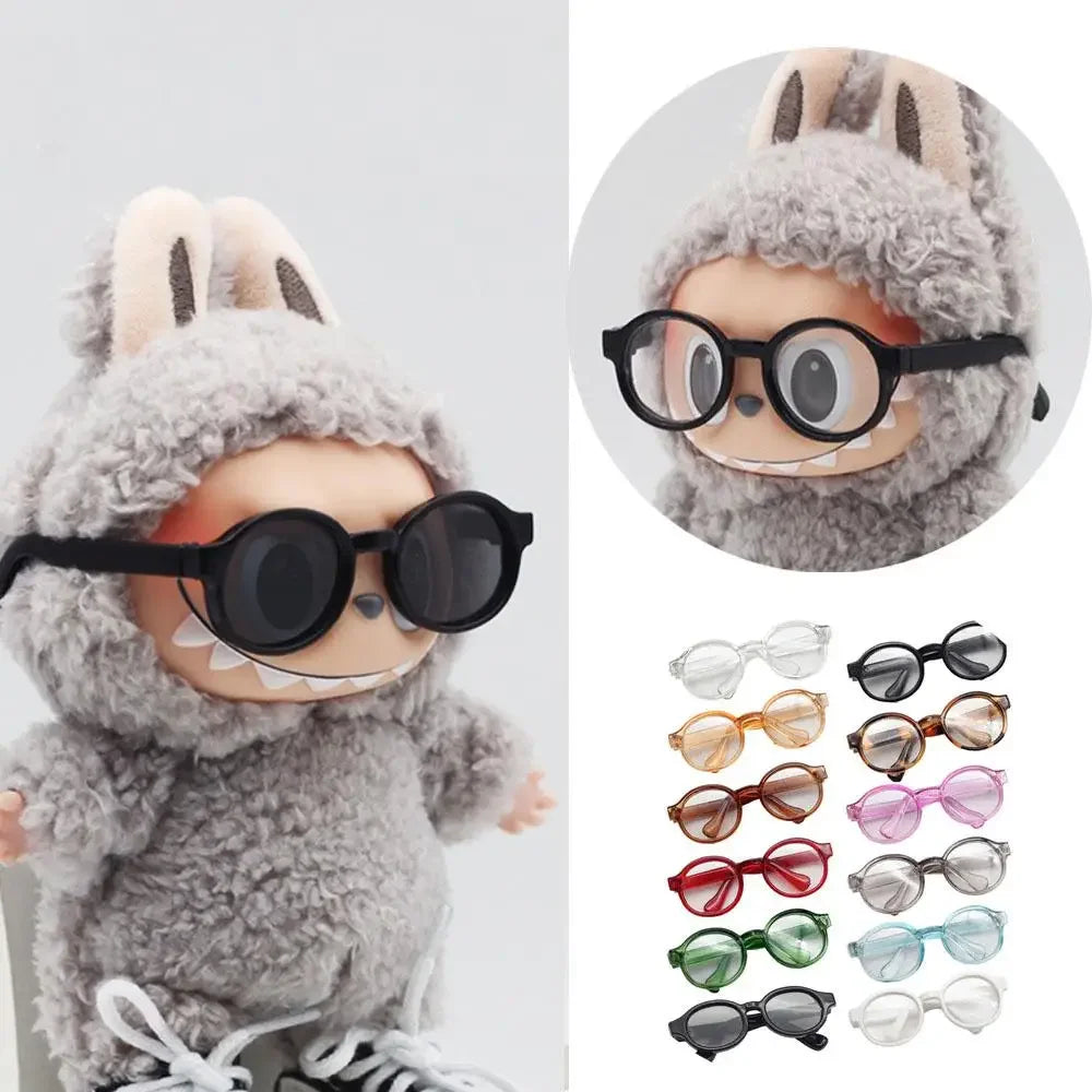 A plush rabbit doll wearing black sunglasses and a fluffy gray hood.