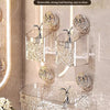 A set of clear glass hanging baskets with a water ripple design mounted on a wall