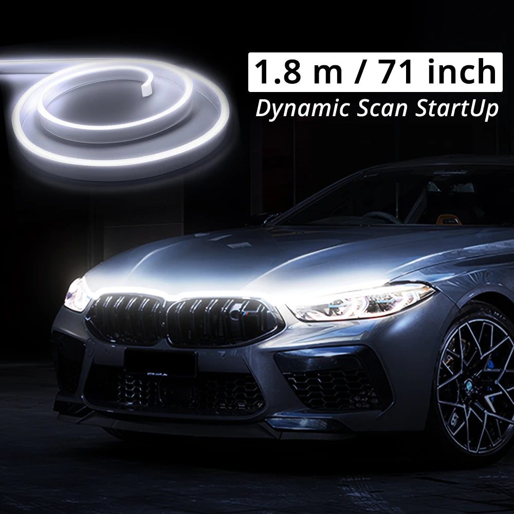 A close-up of a car's front grille and hood showing an LED light strip effect.