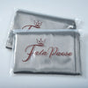 A set of two silky satin pillowcases in gray with a crown design on the fabric.