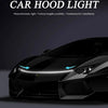 A black car hood illuminated by a bright, monochromatic LED light strip for accent lighting.