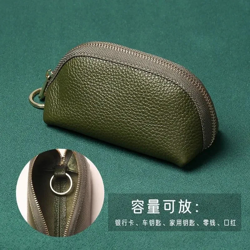 Olive green PU leather key organizer wallet with a zipper shown on a dark green background.