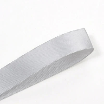 A roll of white double face satin ribbon measuring 25 yards.