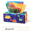 A box of dinosaur tissue paper with silk scarves inside, featuring colorful cartoon dinosaurs.