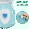 Close-up of a toilet seat with non-slip stickers being applied to the surface.