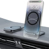 A clear magnetic car phone mount is shown resting on a dark surface in front of a car grille.