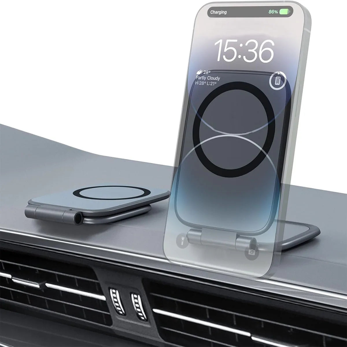 A clear magnetic car phone mount is shown resting on a dark surface in front of a car grille.