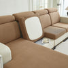 A beige Jacquard stretch sofa slipcover with a white accent panel shown in a bright room.