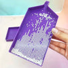 A purple diamond painting organizer tray filled with white seed beads and organized plastic storage case.