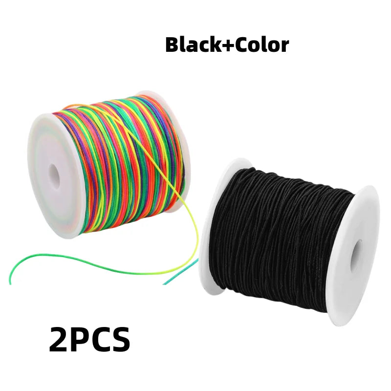Two spools of black and color elastic cord for jewelry making