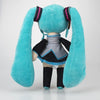 A soft teal plush doll of Hatsune Miku with long ears and a black outfit.