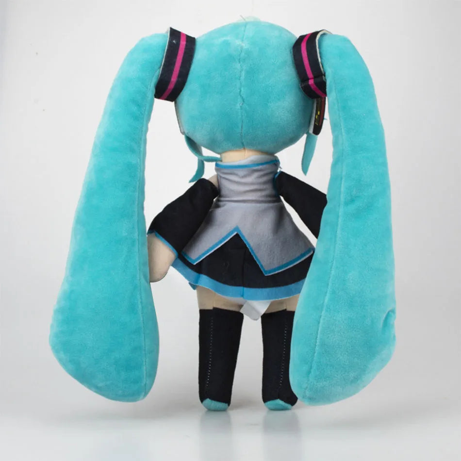 A soft teal plush doll of Hatsune Miku with long ears and a black outfit.