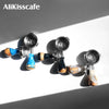 A set of four stainless steel bottomless espresso portafilters with wooden handles for brewing machines.