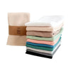 A stack of four waffle weave towels in various pastel and muted colors, including beige, mint green, pink, and gray.