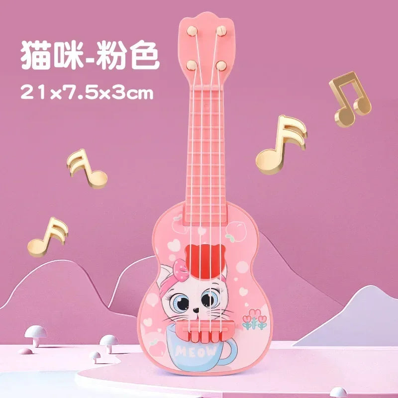 A pink ukulele toy guitar with a cat face design is displayed against a light pink background.