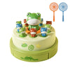 A game featuring various frog figures, including a large central frog, displayed on a round green board.