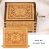 A hand-cranked wooden music box accessory board made of light wood with intricate geometric patterns.