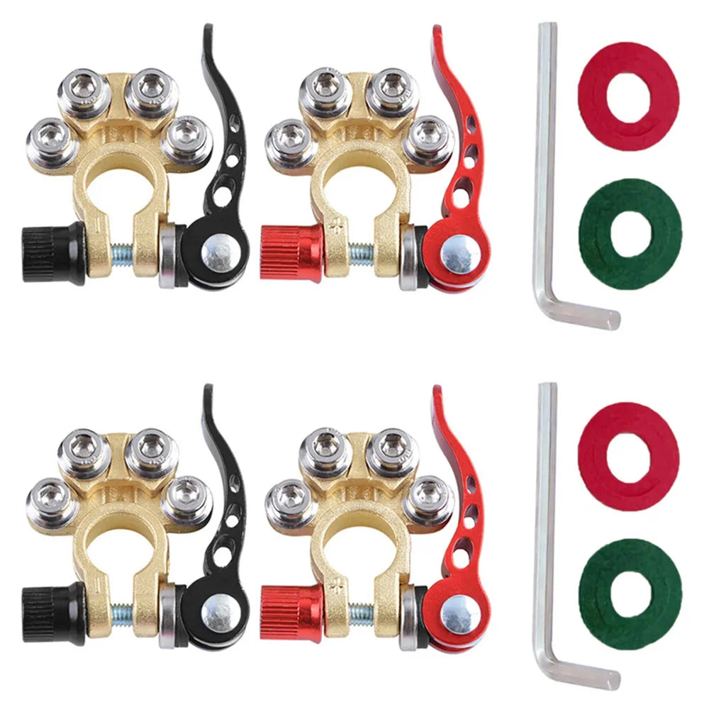 A pair of brass and red quick-release car battery terminal connectors with insulated wires.
