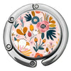 A close-up of a silver bag hook with a circular, multi-patterned floral design on the surface.