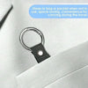 A black durable polyester luggage strap with a silver ring and ID tag is clipped onto a light gray suit jacket pocket.