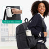 A woman wearing a navy blue cardigan and skirt carries a black laptop backpack with side pockets, demonstrating its capacity 