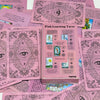 A box of Pink Learning Tarot cards featuring various spreads and illustrations.