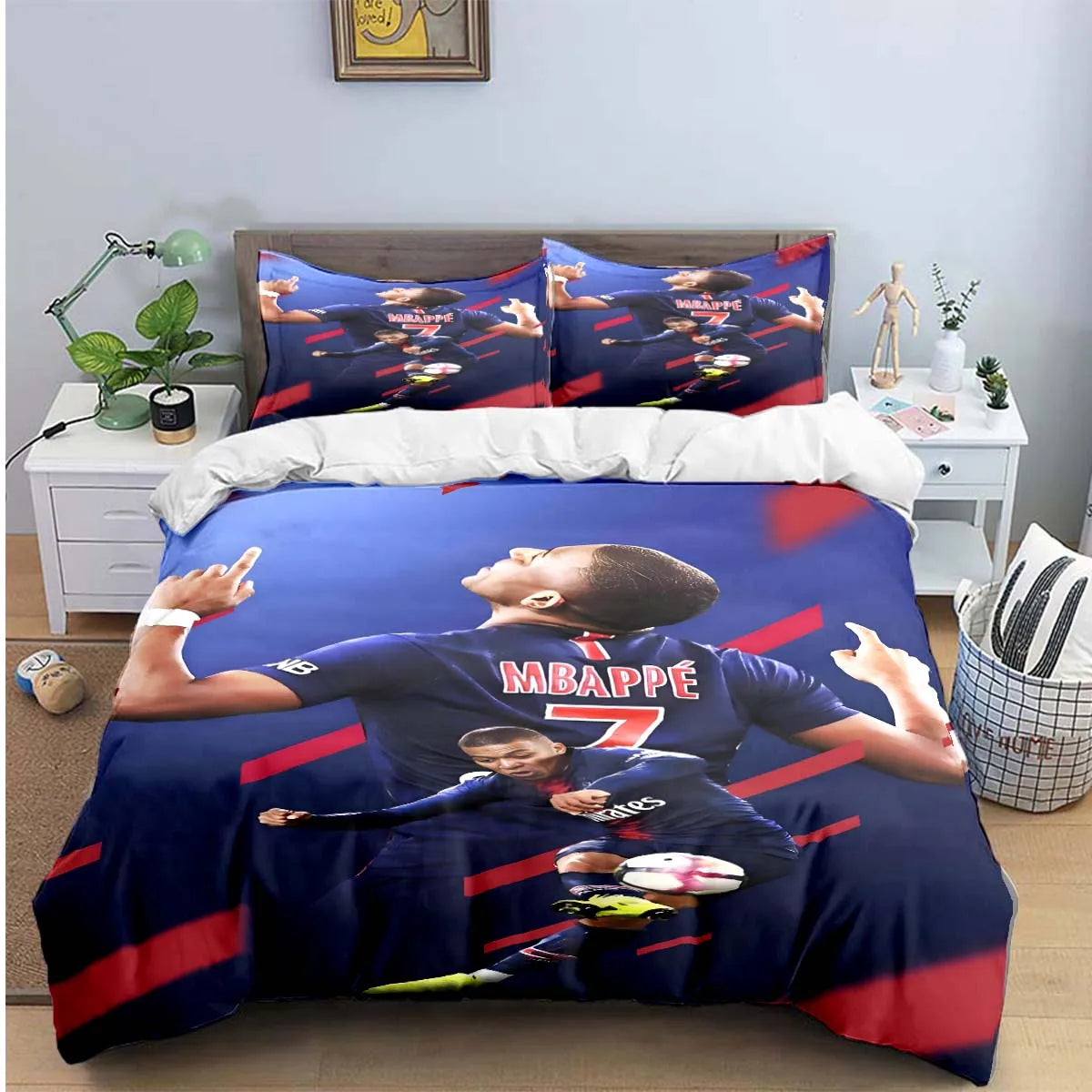 A dark blue duvet cover featuring a soccer player, Mbappé, in a jersey, with matching pillowcases.