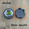 Old style black wheel center hub caps for Nissan models shown with a green leaf label