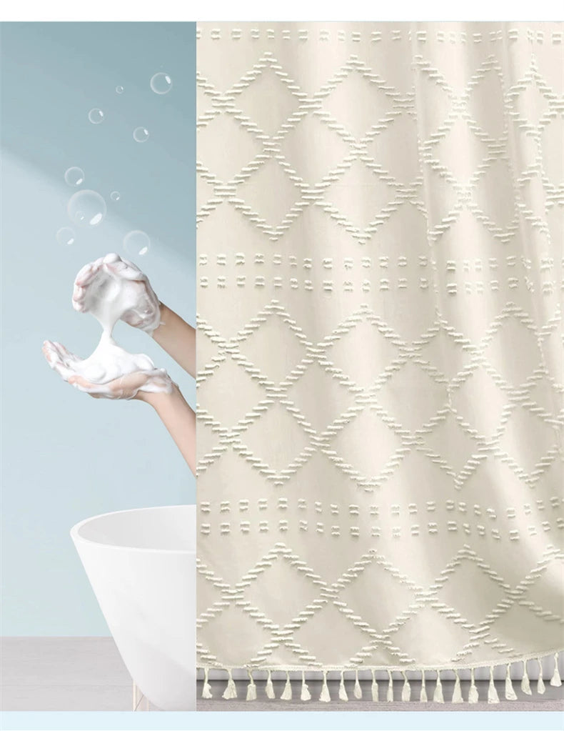 A beige boho waterproof shower curtain with diamond pattern and tassels hanging in a bathroom.