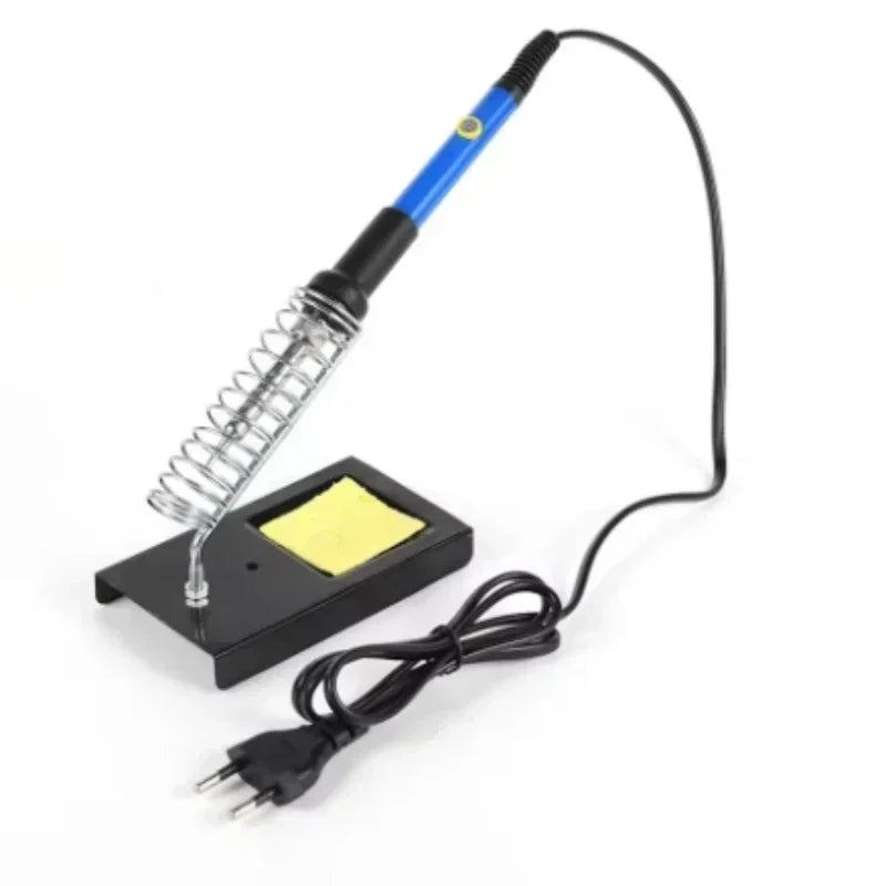A soldering iron kit with a coiled tip, multimeter, and power cord lying on a white background.
