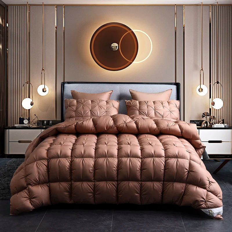 A luxurious brown quilted duvet and pillows displayed on a bed with modern gold accents.