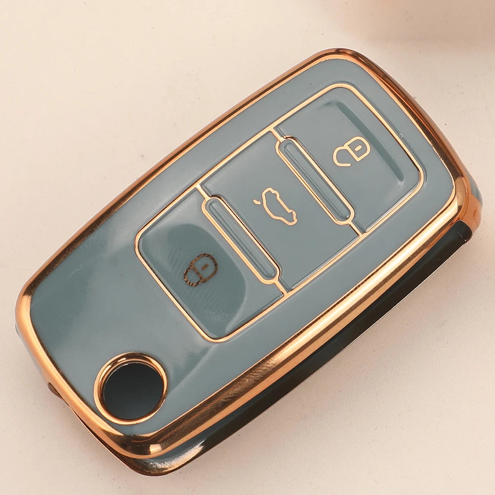 A light blue silicone car key case with gold accents, featuring multiple slots for flip keys.