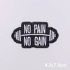 Black embroidered iron-on patch with the text NO PAIN NO GAIN stitched in white thread