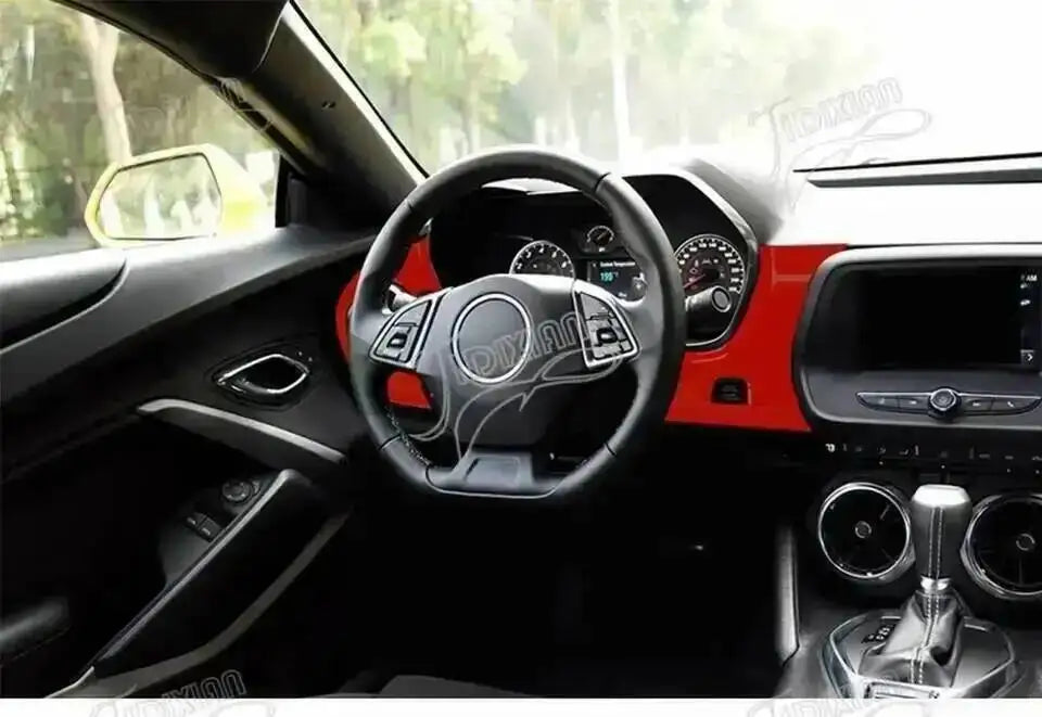 Interior view of a Chevrolet Camaro showing red trim and steering wheel.