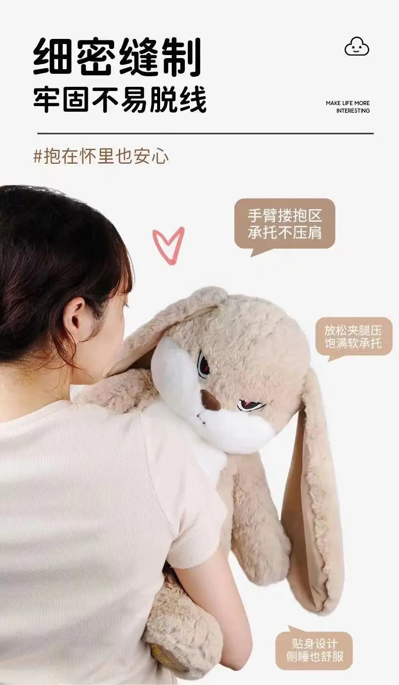 A person is holding an oversized long-eared angry rabbit plush toy, demonstrating its soft texture and design.
