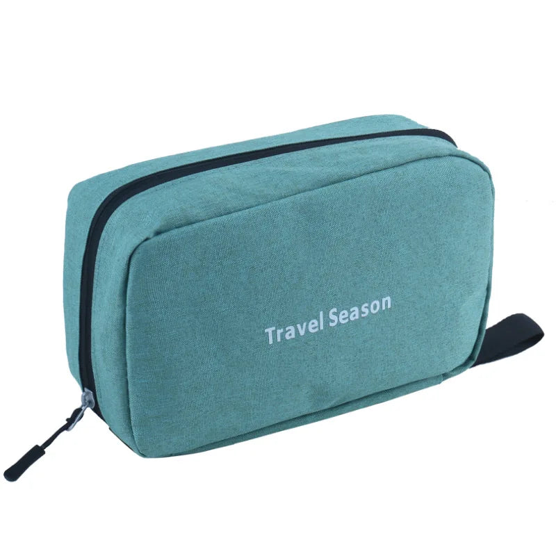 A teal hanging toiletry bag with a black trim and strap, featuring the text Travel Season.