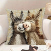 A decorative pillow featuring a realistic depiction of two close donkeys with expressive faces.