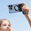 A hand holds a phone attached to a magnetic tripod with a lens and light, ready for shooting.