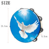 A round wooden hand tambourine with steel jingles featuring a white dove in flight against a blue sky background.