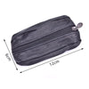 A black leather compact zippered coin purse with a metal key holder attached.