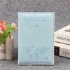 Light blue leather passport holder with embossed world map and airplane design