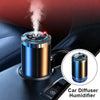 A car diffuser humidifier emitting white vapor, shown in a dark car interior.